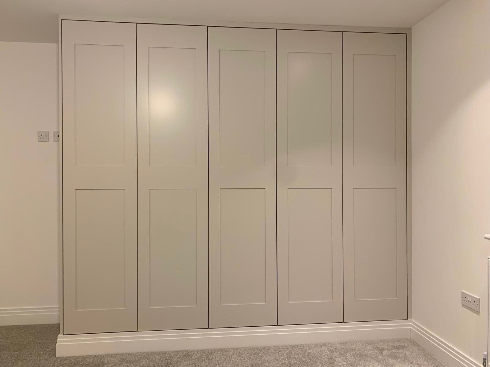 Elegant fitted wardrobe with sleek finish and integrated storage solutions